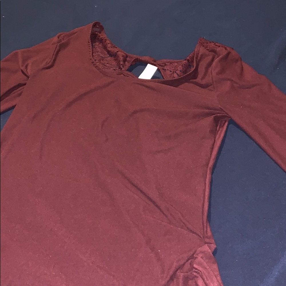 Cute long sleeve soft top with top lace in back.